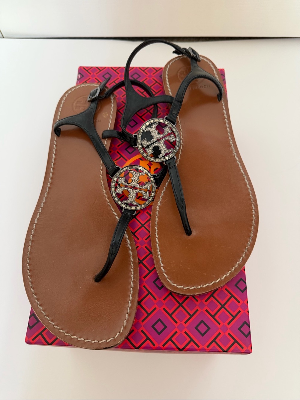 Tory Burch Black patent Leather T-Strap Sandals with Gunmetal Gem Logo Medallion